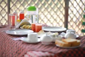 a table with plates of food and fruit on it at Cherai Beach Residency in Cherai Beach