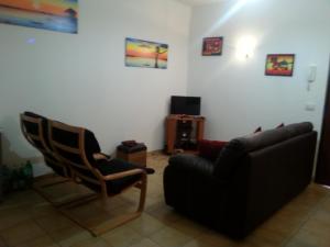 a living room with a couch and a chair at Lina Apartments C1 in Ginosa Marina