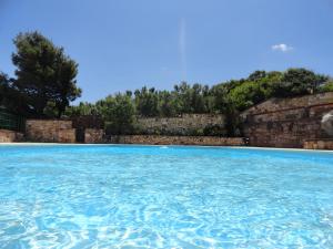 a large swimming pool with blue water at TANIT Hotel Ristorante Storia del SulcisIglesiente in Carbonia