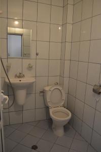 a bathroom with a toilet and a sink at хотел Европа in Shumen
