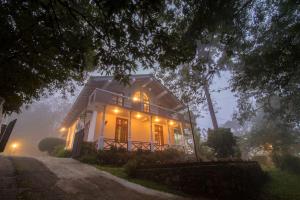 a house is lit up at night with lights at Estancia Holiday Bungalow in Matale