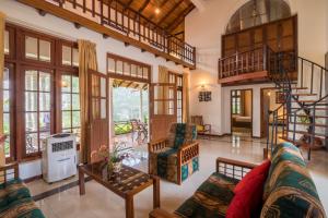 a living room with a couch and a table at Estancia Holiday Bungalow in Matale