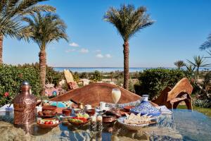 a table with food on it with palm trees at Lazibinn Boutique Hotel in Tunis