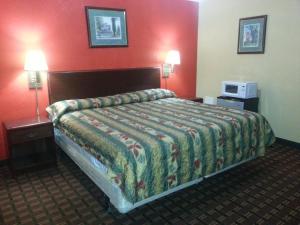 a hotel room with a bed and two night stands at Mount Laurel Motel in Hazleton