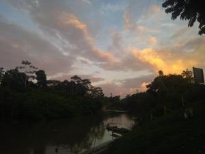 a view of a river with a sunset in the background at Hotel Juruá in Cruzeiro do Sul