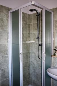 a shower with a glass door in a bathroom at Hotel Ristorante Da Marco in San Mauro a Mare