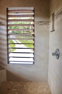 a bathroom with a shower with a window at Casa Marchele - 2 Bedrooms & Loft in West Bay