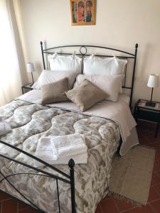 a bedroom with a large bed with white pillows at La finestra sulla Toscana in Cortona