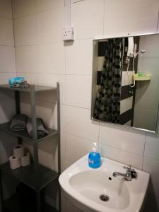 a bathroom with a sink and a mirror at Comfort Zone @ The CEO Loft by Joal in George Town +9 photos