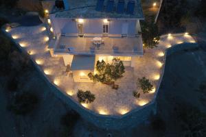an aerial view of a house with lights at Skouros Villa in Kastrí