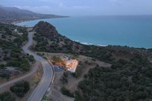 an aerial view of a house on a hill next to the ocean at Skouros Villa in Kastrí