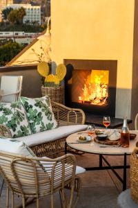 a patio with a fireplace and a table and chairs at Hotel 850 SVB West Hollywood at Beverly Hills in Los Angeles