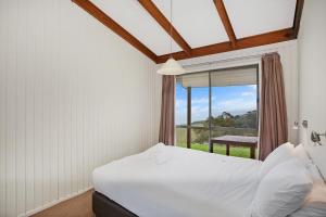 A bed or beds in a room at Beacon Point Ocean View Villas