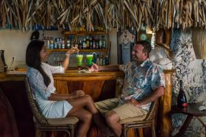 a man and a woman sitting at a bar at Ninamu Resort in Tikehau +55 photos