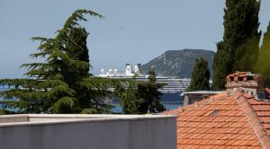 a view from the roof of a house with a cruise ship in the background at Apartments Beautiful Sandy Beach in Split