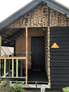 a brick building with a door and a porch at Beach Shack Chalet - Garden View Aframe Big Unit in Tioman Island