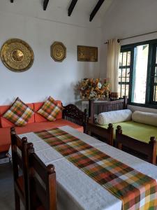 a living room with two beds and a couch at Florence Cottage in Beddegama