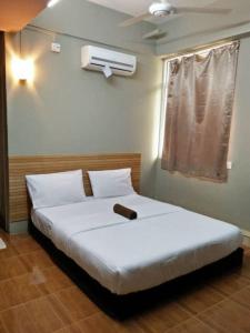 Voodi või voodid majutusasutuse Qing Yun Rest House Gadong 1st branch toas