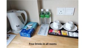 a counter with two bottles of water and a blender at Hotel Dutaria in Ipoh