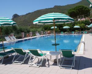 a pool with chairs and a table with an umbrella at Hotel Ristorante Borgo La Tana in Maratea