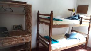 a room with two bunk beds and a fireplace at Casa térrea in Paraty