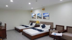 Giường trong phòng chung tại Grand Pearl Minh Chau - Quan Lan