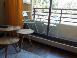 a room with two tables and chairs and a window at Departamento Pucon in Pucón