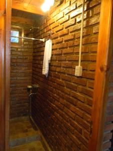 Hogar de la luna في مونتي كاسيروس: حمام بجدار من الطوب ومنشفة