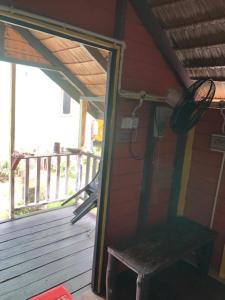 a wooden porch with a bench on a deck at Beach Shack Chalet - Garden View Aframe Big Unit in Tioman Island