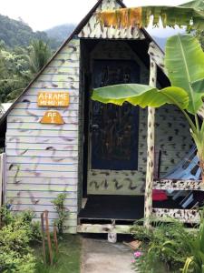 a small house with a door with a sign on it at Beach Shack Chalet - Garden View Aframe Big Unit in Tioman Island
