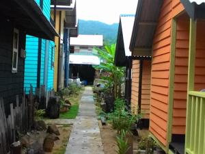a walkway between two houses in a city at Beach Shack Chalet - Garden View Aframe Big Unit in Tioman Island