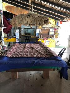 a table in a room with a largeoit at Beach Shack Chalet - Garden View Aframe Big Unit in Tioman Island