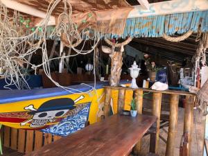 a restaurant with a wooden table and a bench at Beach Shack Chalet - Garden View Aframe Big Unit in Tioman Island
