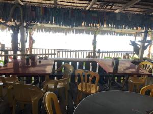 a group of tables and chairs in a restaurant at Beach Shack Chalet - Garden View Aframe Big Unit in Tioman Island