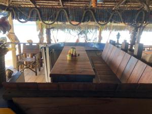 a large wooden table in a room with a tableablish at Beach Shack Chalet - Garden View Aframe Big Unit in Tioman Island