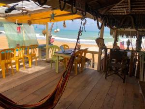 a porch with a table and chairs on the beach at Beach Shack Chalet - Garden View Aframe Big Unit in Tioman Island