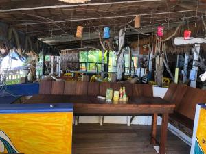 a restaurant with a wooden table in a room at Beach Shack Chalet - Garden View Aframe Big Unit in Tioman Island