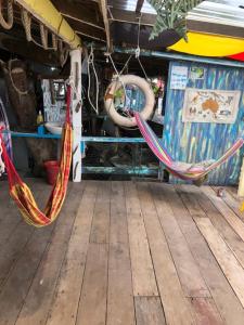 two hammocks are hanging on a wooden deck at Beach Shack Chalet - Garden View Aframe Big Unit in Tioman Island