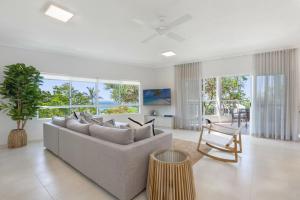 a living room with a couch and a chair at The Lookout Resort Noosa in Noosa Heads