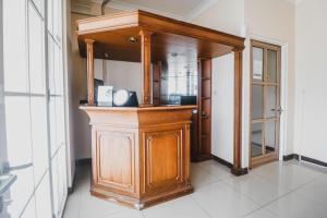 a wooden cabinet with a mirror in a room at RedDoorz @ Pandu Raya Bogor in Bogor