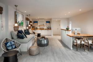 a living room with a couch and a table at Blue Sands Inn, A Kirkwood Collection Hotel in Santa Barbara