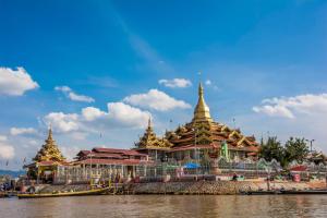 a group of pagodas on the side of a river at Inle Star Hotel in Nyaungshwe Township