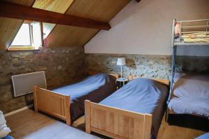 a room with two bunk beds in a attic at Maison du Coué Pyrénées Mourtis Gîte pour 2 à 12 pers in Sengouagnet