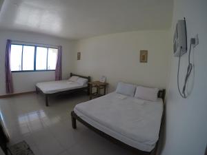 Un pat sau paturi într-o cameră la Se San Beach Resort-Isla de Gigantes