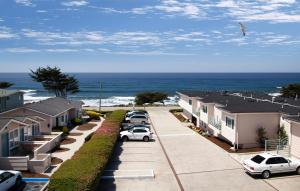 a row of houses and cars parked in a parking lot at Cambria Landing Inn and Suites in Cambria