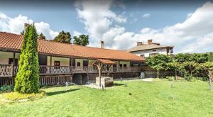 a house with a yard in front of it at Fortuna Apartments in Bansko
