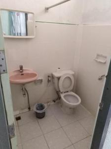 a bathroom with a toilet and a sink at Top North Guest House in Chiang Mai