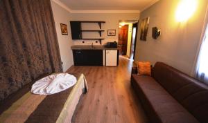 a living room with a couch and a kitchen at Hisar Holiday Club in Oludeniz