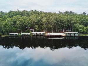 a boat sitting on top of a dock next to a body of water at RAC Karri Valley Resort in Beedelup