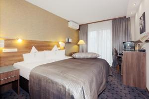 Postel nebo postele na pokoji v ubytování Hotel An der Wasserburg